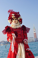Obraz premium beautiful red mask on quay at the carnival in Venice