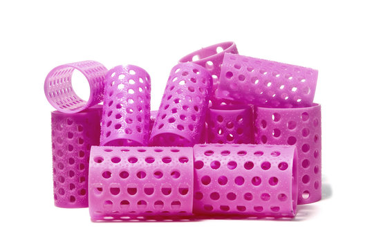 closeup of a few pink hair curlers