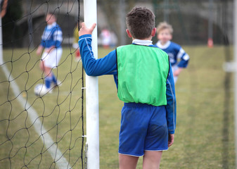 Jeune footballeur protégeant son but