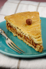 Pecan pie slice with a  silver fork and turquoise plate
