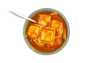 Beef ravioli with fork in a bowl