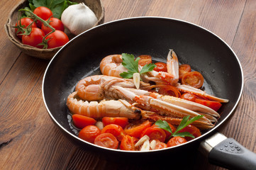 scampi with tomatoes on wood