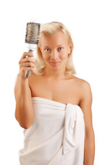 Cheerful blonde combs hair