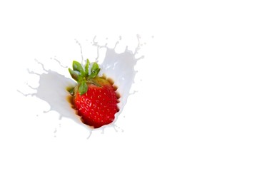Strawberry splashing into milk