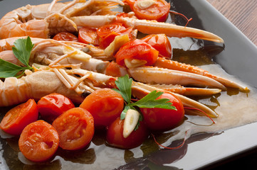 dish with scampi and tomatoes close up