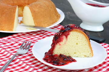 Fresh baked pound bundt cake with fruit sauce.
