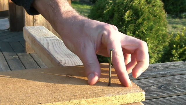 hammering a nail through wood. HD 1280x720 30P
