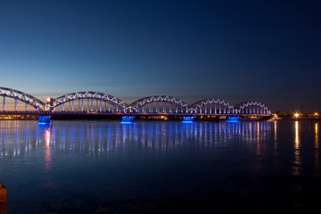 Blue railway bridge at night