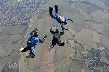 Camera man filming two skydivers