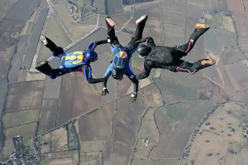 Printed kitchen splashbacks Air sports Three skydivers in freefall high up in the air