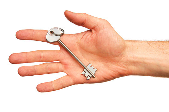 Key in a hand isolated on white background