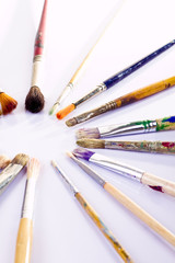 Fototapeta premium Used paint brushes of different colors