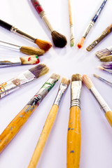 Fototapeta premium Used paint brushes of different colors