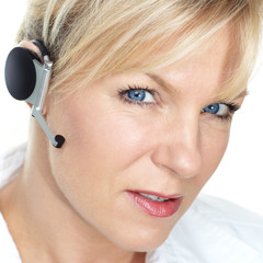 beautiful business girl calling with a bluetooth headset