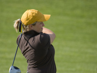Female College Golfer Swinging Fairway Wood