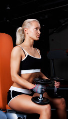 Fototapeta premium Blond Athlete holding dumbbells