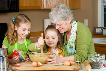 Grandmother teaching kids to bake