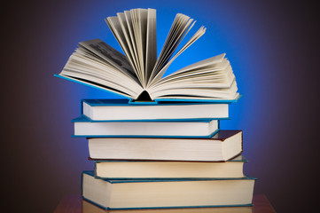 Stack of books against gradient background