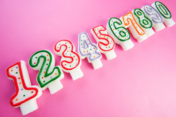 Birthday candles against colourful background