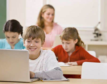 Student using laptop in classroom