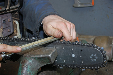 manual worker working on a chain saw