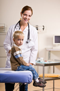 Doctor giving boy checkup in doctor office