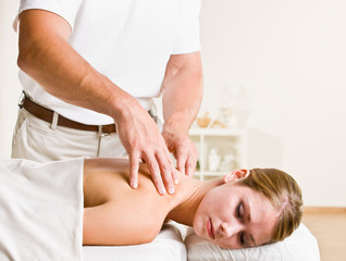 Fototapeta na wymiar Massage therapist giving woman massage