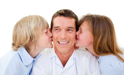 Cute siblings kissing their father