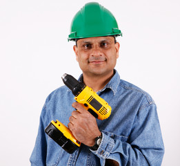 worker with cordless drill