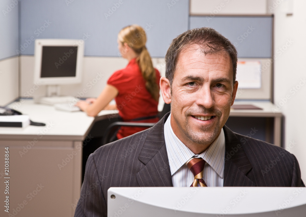 Wall mural businessman sitting at desk smiling