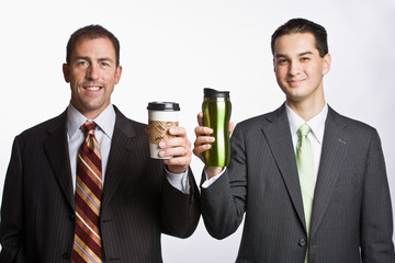 Businessmen holding coffee cups
