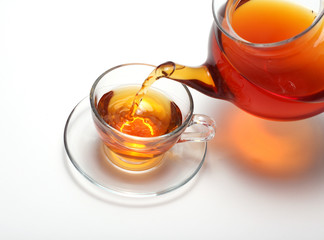Pouring tea to a teacup
