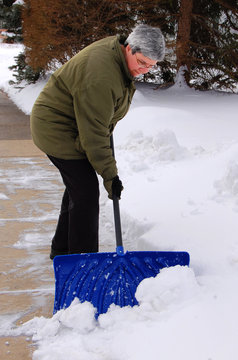 Middle Aged Woman Shoveling