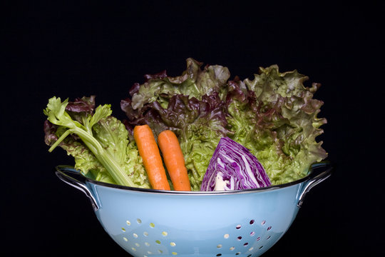 Salad veggies in a colander.