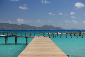 Jetty on tropical paradise Anguilla with view to St. Martin - obrazy, fototapety, plakaty