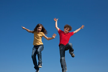 Girl and boy jumping, running outdoor