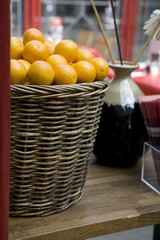 The big wattled decorative basket with oranges in cafe