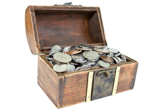 Opened wooden chest with different coins in it