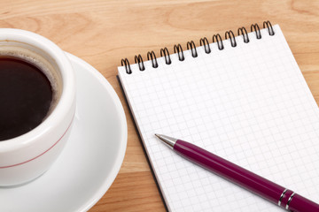 Espresso cup with blank notepad and pen