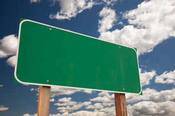 Blank Green Road Sign Over Clouds