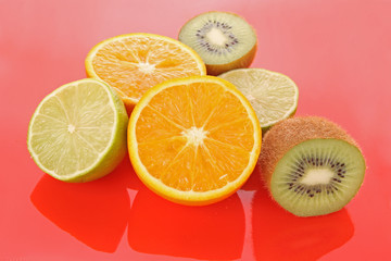 Obraz na płótnie Canvas Orange and other fruits on red