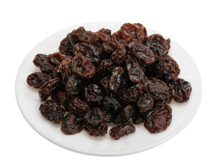 Raisin on a white plate on a white background