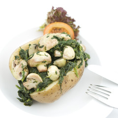 Potato with mushrooms and spinach on white. Vegetarian food