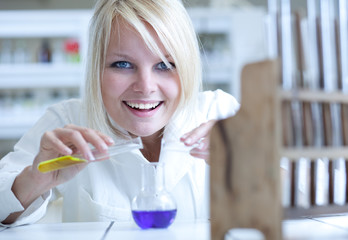 Closeup of a female researcher carrying out an experiment in a l