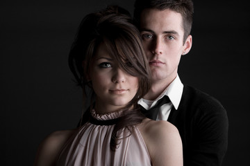 Young Couple against Dark Background