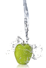 fresh water splash on green apple isolated on white