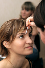 Fototapeta premium beautiful young girl doing makeup