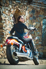 Fototapeta na wymiar The young beautiful girl on a red motorcycle