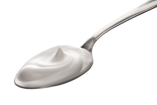 little spoon of milk cream isolated on white