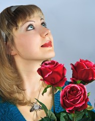 beautiful woman holds bouquet of red roses